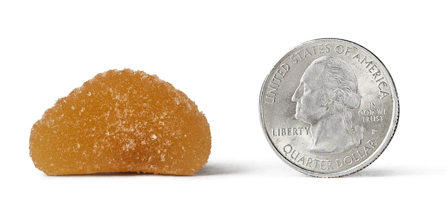 Airborne Kids Gummy next to a quarter coin